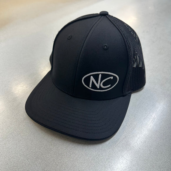 BLACK CURVED BILL PACIFIC HEADWEAR FITTED TRUCKER HAT WITH NC OVAL LOGO