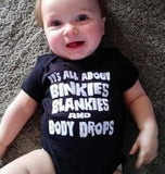 ITS ALL ABOUT BINKIES BLANKIES AND BODY DROPS BLACK ONESIE