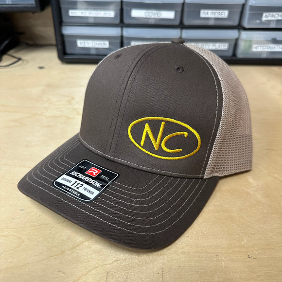 NEGATIVE CAMBER CURVED BILL SNAP BACK HAT WITH GOLD NC OVAL LOGO ON BROWN/KHAKI