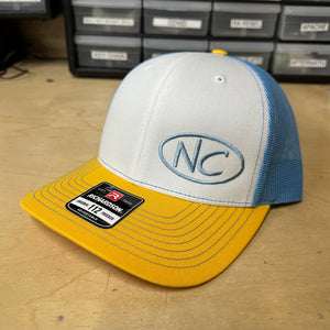 NEGATIVE CAMBER CURVED BILL SNAP BACK HAT WITH BABY BLUE NC OVAL LOGO ON YELLOW/WHITE/BABY BLUE