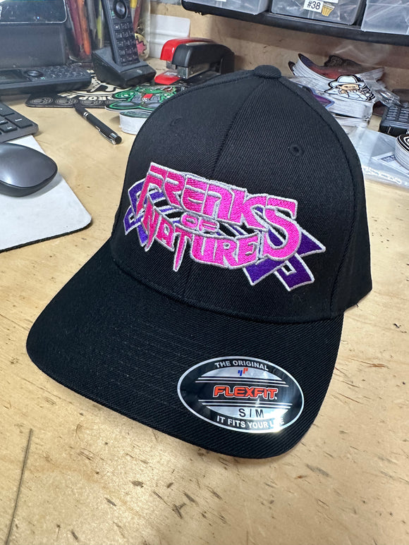 NOVEMBER HAT OF THE MONTH BLACK CURVED BILL FITTED HAT WITH PURPLE TRIBALS WITH PINK FON AND SILVER OUTLINE