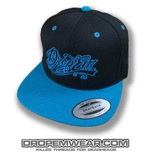 BLACK FLAT BILL SNAP BACK WITH NEON BLUE BILL AND NEON BLUE TATTOO SCRIPT LOGO