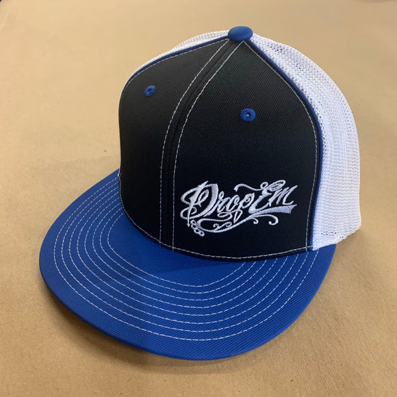 PACIFIC HEADWEAR FLAT BILL FITTED TRUCKER HAT ROYAL/BLACK/WHITE WITH TATTOO SCRIPT LOGO ON LEFT PANEL