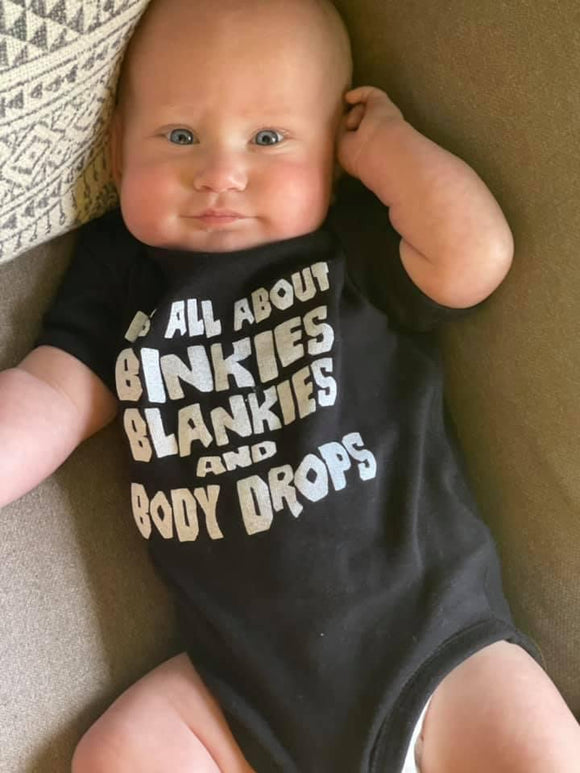 ITS ALL ABOUT BINKIES BLANKIES AND BODY DROPS BLACK ONESIE